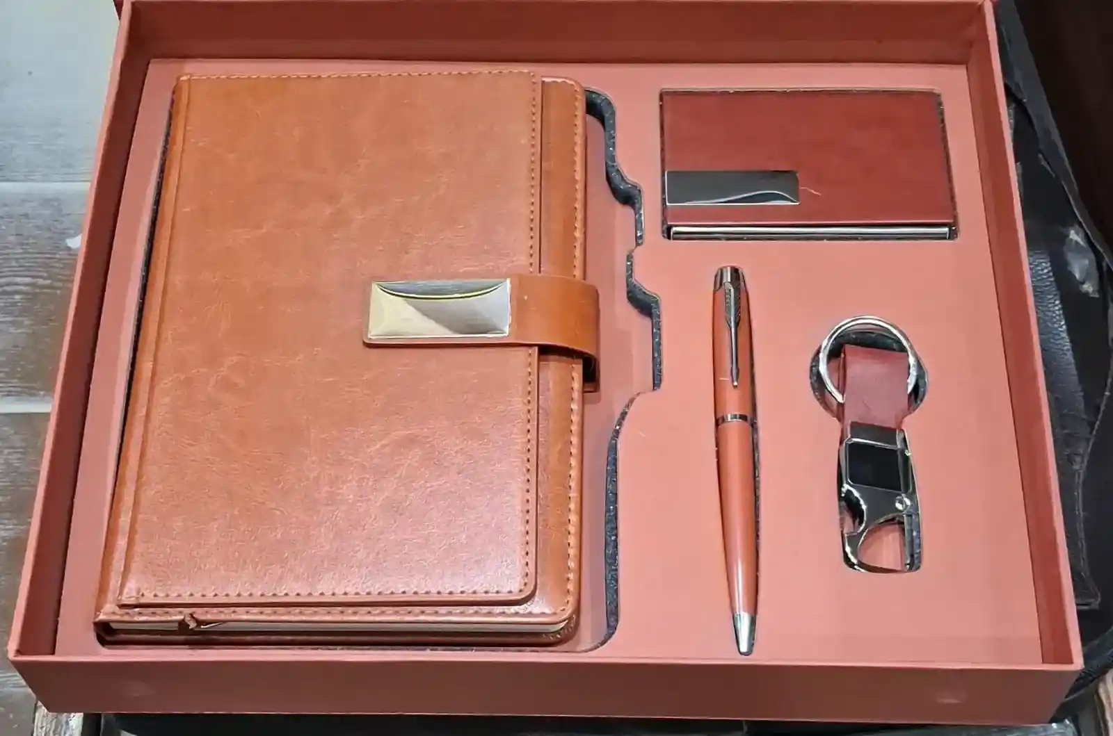 Brown diary, pen, keychain and card holder in an office gift set