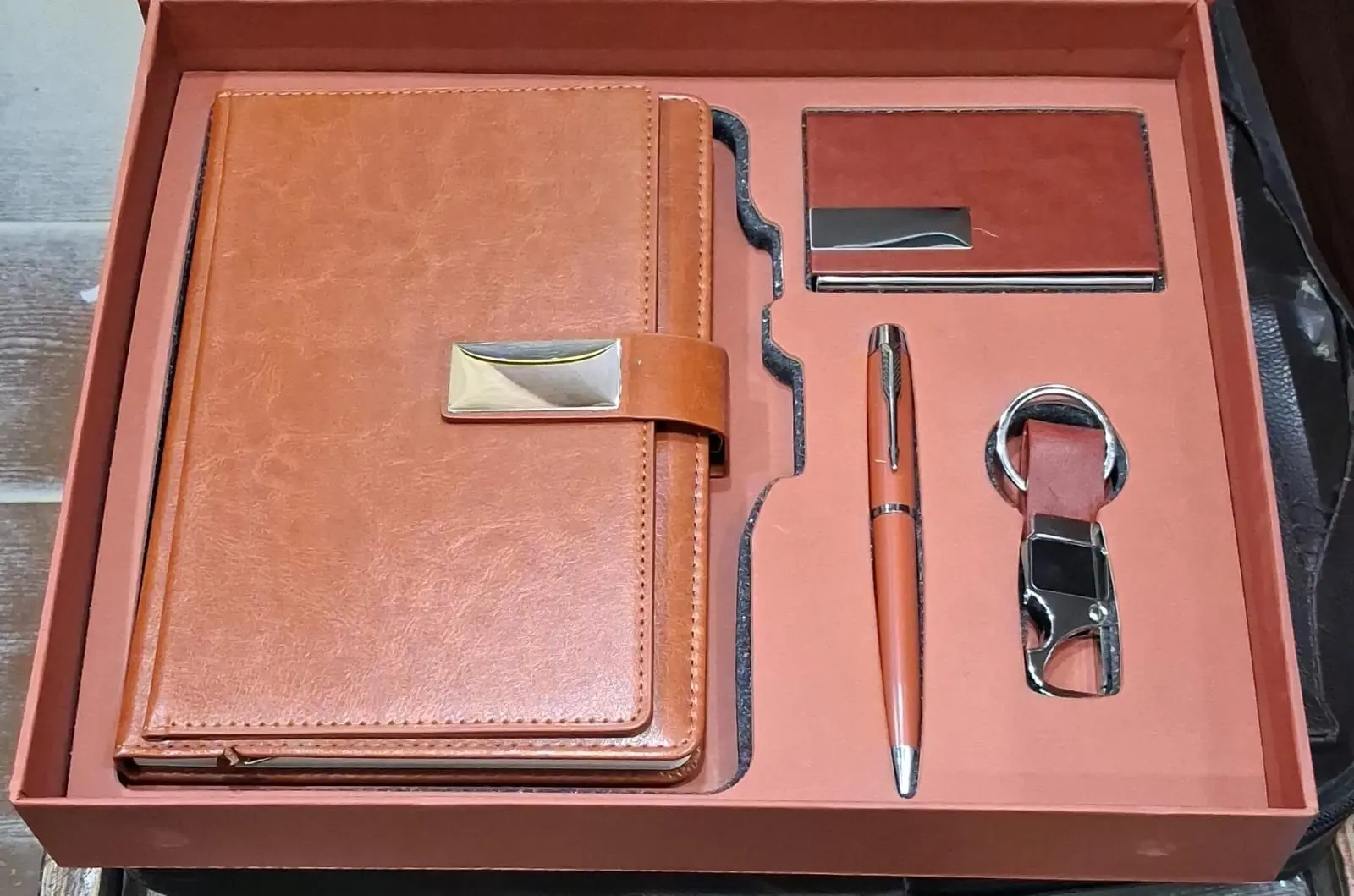 Brown diary, pen, keychain and card holder in an office gift set